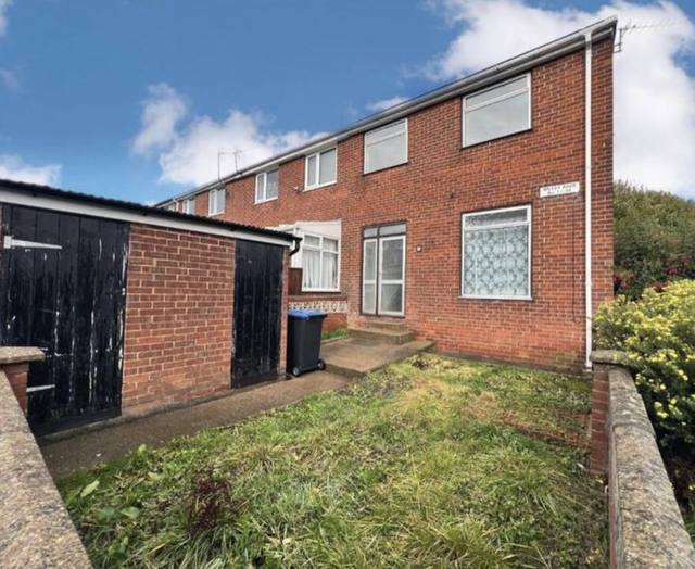 Brick end-terrace house with a front garden